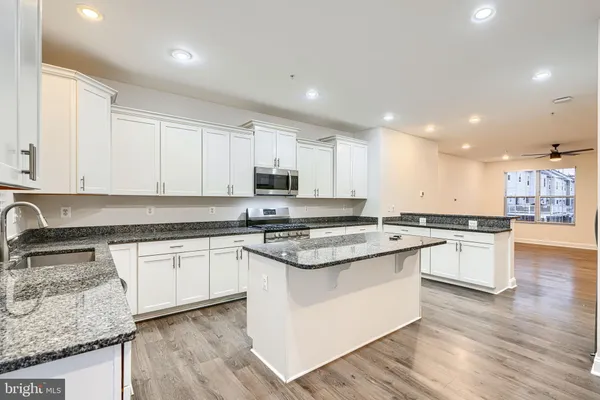 a kitchen with stainless steel appliances granite countertop a stove and a sink
