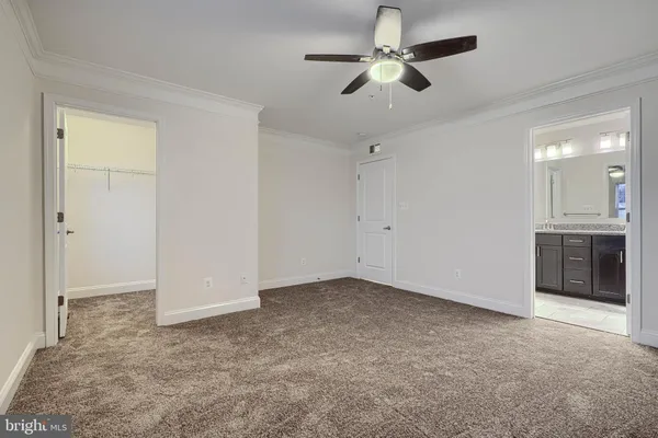 a view of an empty room with a ceiling fan