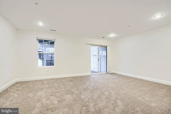 an empty room with windows and closet