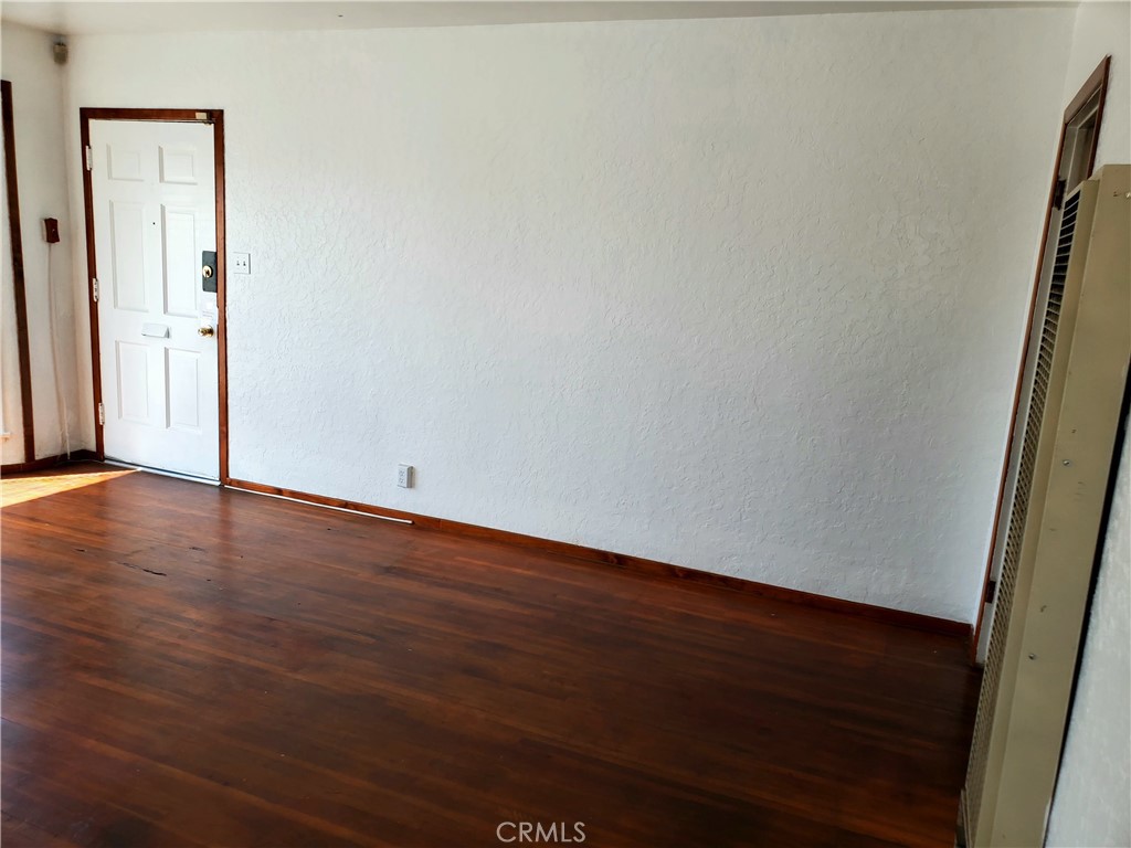 1420 South Butler Avenue Compton, CA 90221 - Photo 15 of 44 an empty room with wooden floor