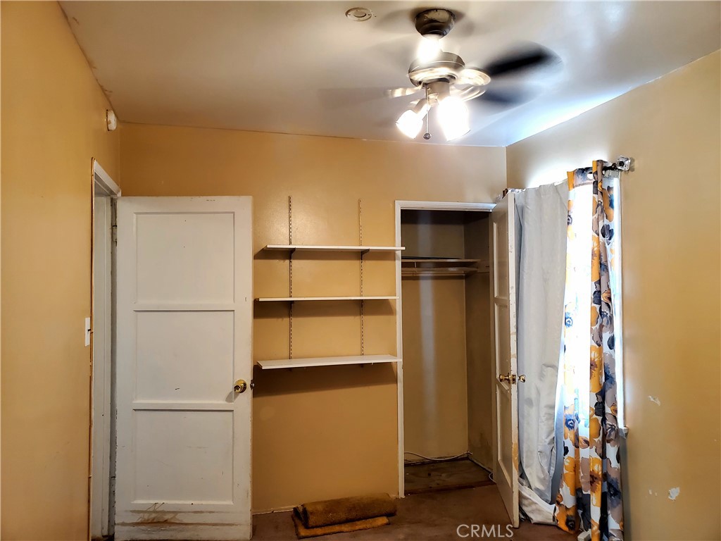 1420 South Butler Avenue Compton, CA 90221 - Photo 26 of 44 a view of an empty room with a ceiling fan and window
