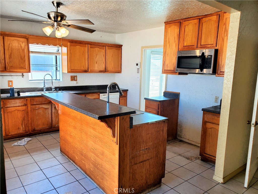 1420 South Butler Avenue Compton, CA 90221 - Photo 30 of 44 a kitchen with stainless steel appliances granite countertop a sink stove and refrigerator