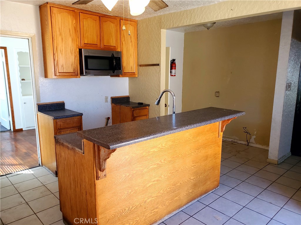 1420 South Butler Avenue Compton, CA 90221 - Photo 31 of 44 a kitchen with stainless steel appliances a sink a microwave a refrigerator and a window