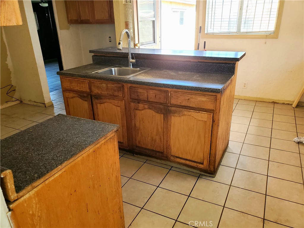 1420 South Butler Avenue Compton, CA 90221 - Photo 32 of 44 a kitchen with a sink and a refrigerator