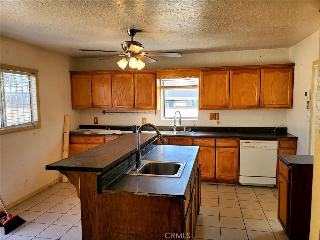 1420 South Butler Avenue Compton, CA 90221 - Photo 34 of 44 a kitchen with stainless steel appliances granite countertop a sink a stove a refrigerator cabinets and a dining table