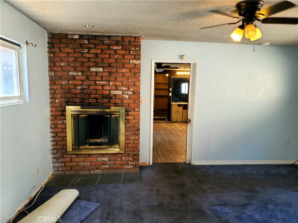 1420 South Butler Avenue Compton, CA 90221 - Photo 40 of 44 a view of empty room with a fireplace and wooden floor