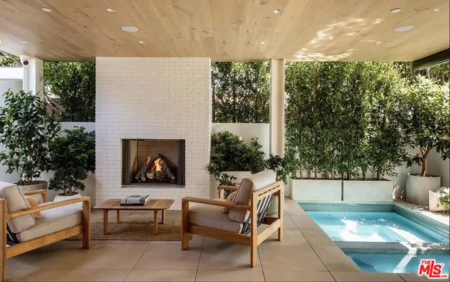 a outdoor living space with furniture and a fireplace