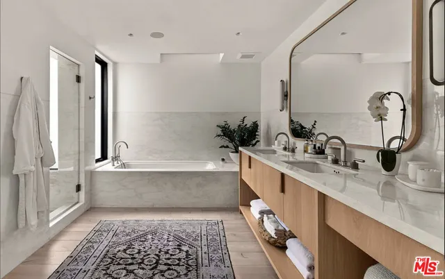 a bedroom with a bed and glass window