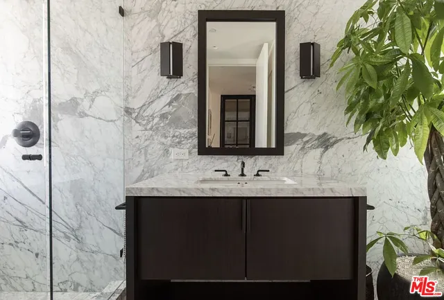 a bedroom with a bed and a night stand