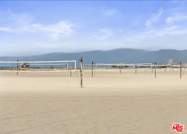 a front view of a building with palm trees