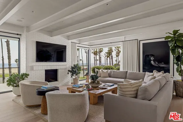 a living room with fireplace furniture and a flat screen tv