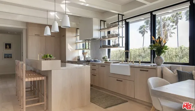 a kitchen with a table chairs refrigerator and cabinets