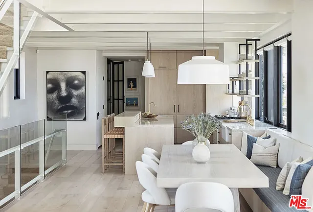 a view of a dining room with furniture and chandelier