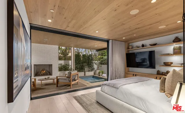 a bedroom with furniture and a large window