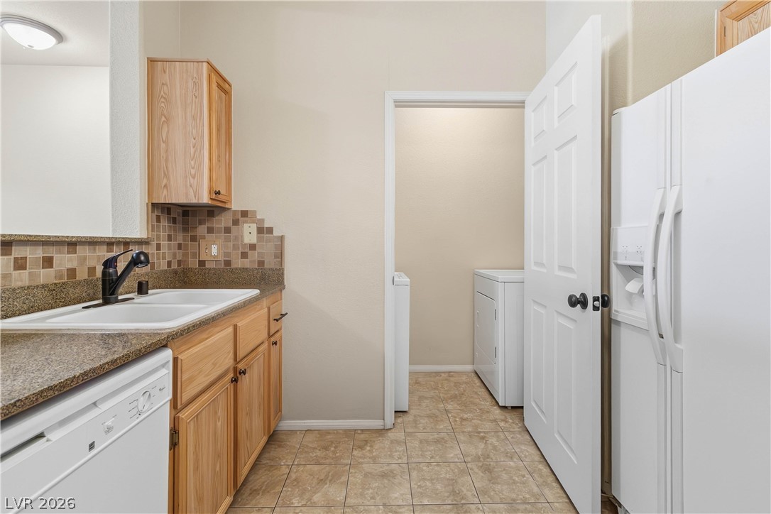 10550 West Alexander Road, Unit 2060 Las Vegas, NV 89129 - Photo 21 of 45 A functional kitchen provides ample space for culinary endeavors and an adjacent utility area for convenience.