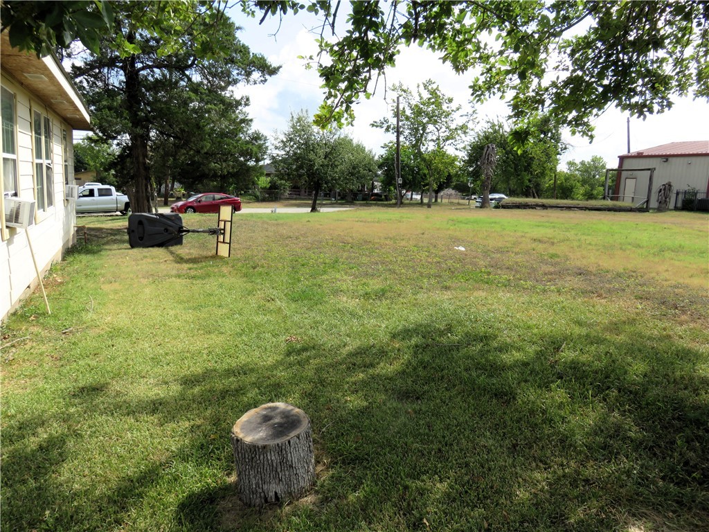 1413 Sandy Point Road Bryan, TX 77803 - Photo 18 of 23 a backyard of a house with barbeque oven table and chairs