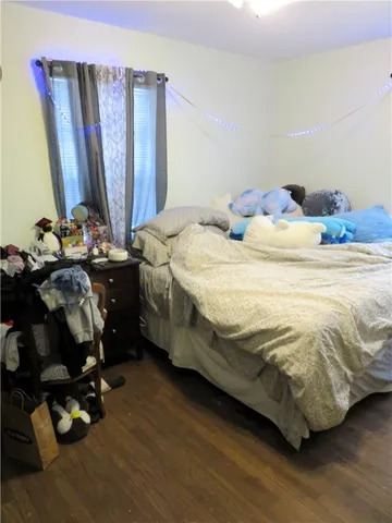 a bedroom with a bed and a mirror