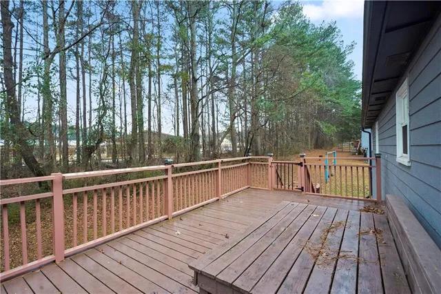 a view of balcony with wooden floor and fence