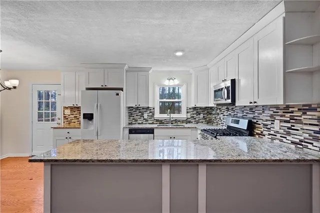 a kitchen with counter top space cabinets and stainless steel appliances