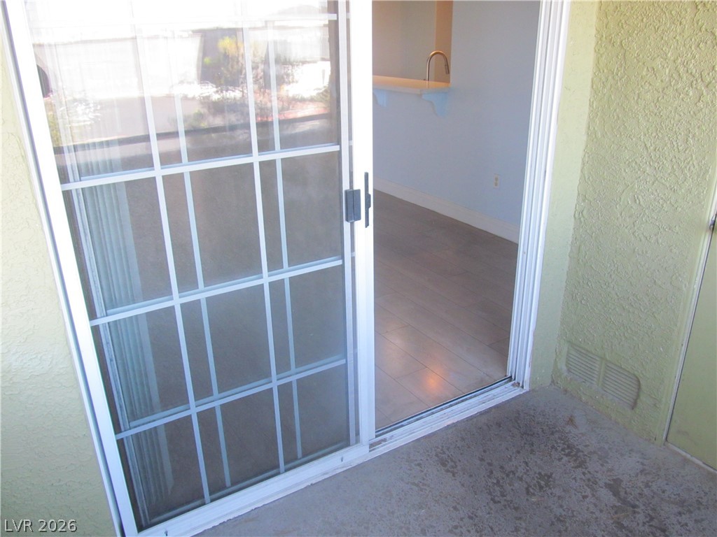 7950 West Flamingo Road, Unit 2048 Las Vegas, NV 89147 - Photo 13 of 24 Step through sliding glass doors to a private patio, extending the living space outdoors.