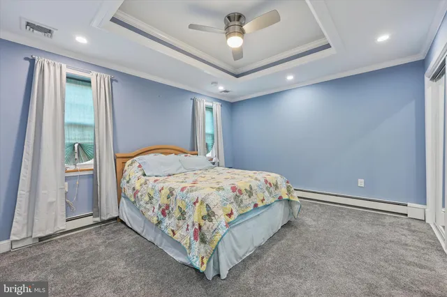 a spacious bedroom with a bed and a window