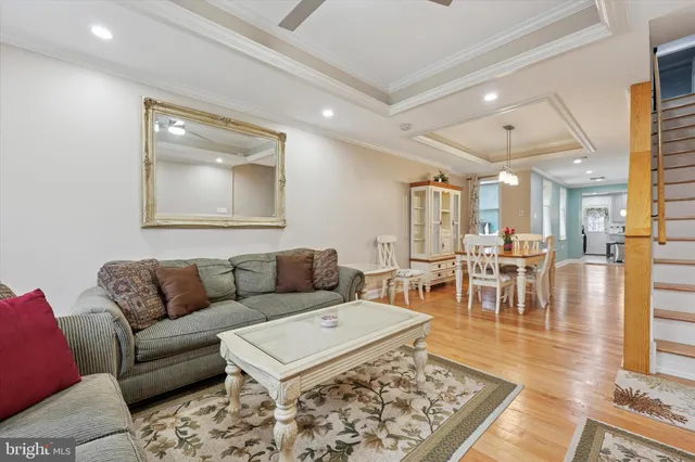 a living room with furniture a rug and a table
