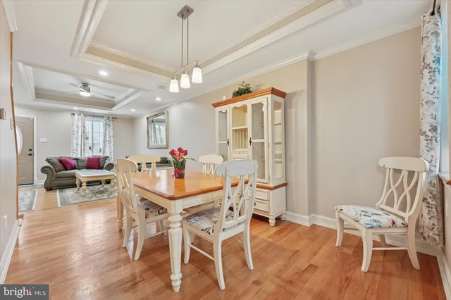 a view of a dining room with furniture wooden floor and chandelier