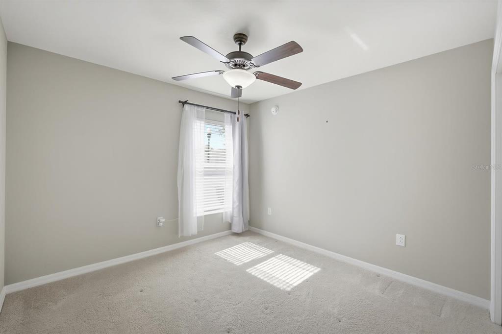 212 Serena Ridge Drive Seffner, FL 33584 - Photo 18 of 22 an empty room with closet and a chandelier fan