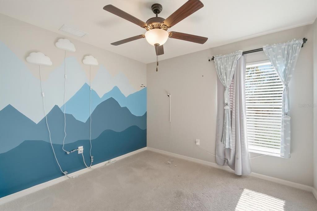 212 Serena Ridge Drive Seffner, FL 33584 - Photo 19 of 22 a view of a room with a ceiling fan and a window