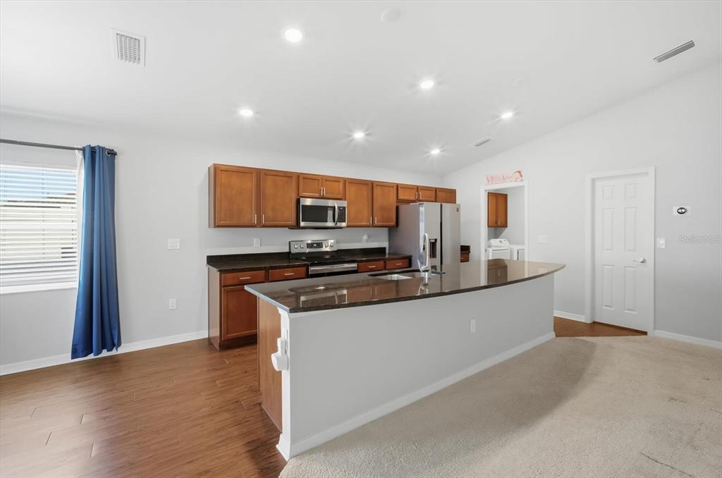 212 Serena Ridge Drive Seffner, FL 33584 - Photo 7 of 22 a large kitchen with stainless steel appliances granite countertop a stove and a refrigerator