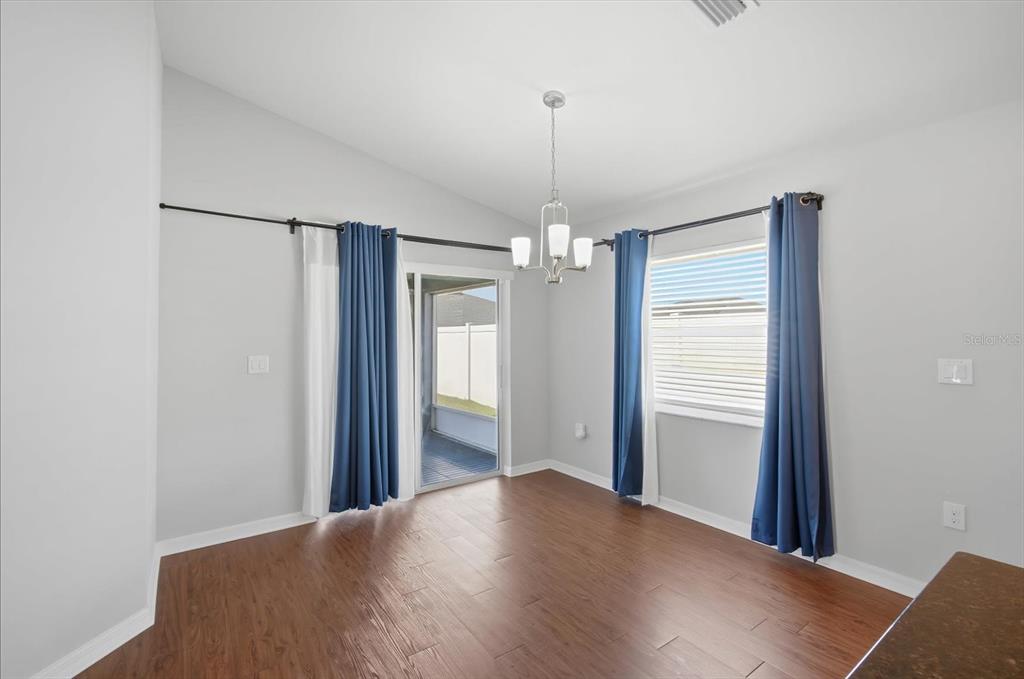 212 Serena Ridge Drive Seffner, FL 33584 - Photo 9 of 22 a view of a room with wooden floor staircase and a chandelier
