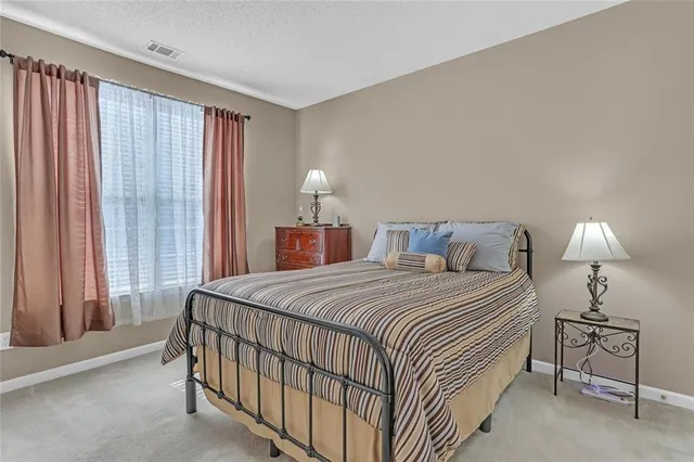 a bedroom with a bed and a lamp