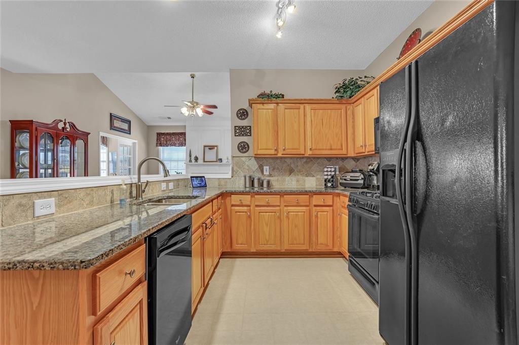 314 Gable Brook Drive Southwest Grayson, GA 30017 - Photo 14 of 26 a kitchen with stainless steel appliances granite countertop a sink refrigerator and cabinets