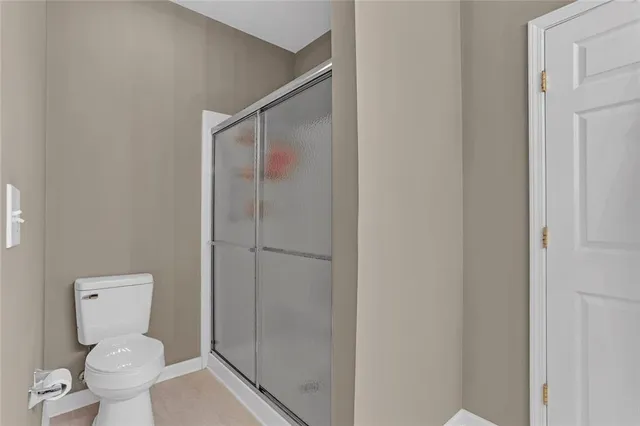 a bathroom with a toilet and a shower