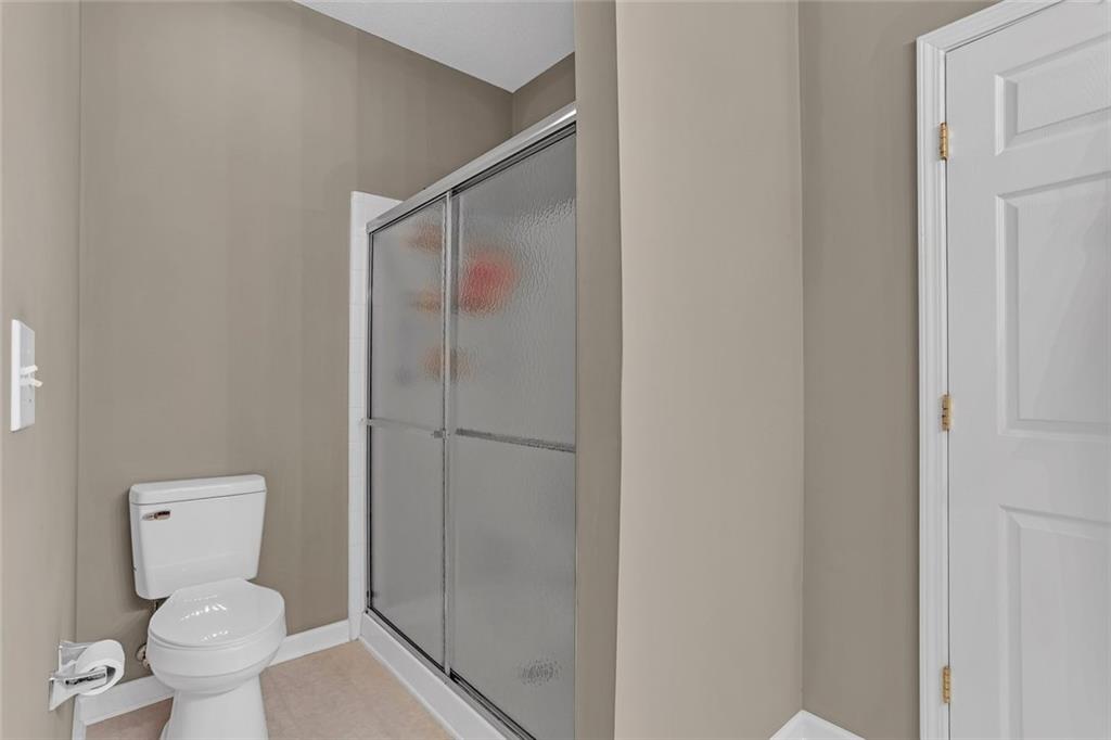 314 Gable Brook Drive Southwest Grayson, GA 30017 - Photo 19 of 26 a bathroom with a toilet and a shower