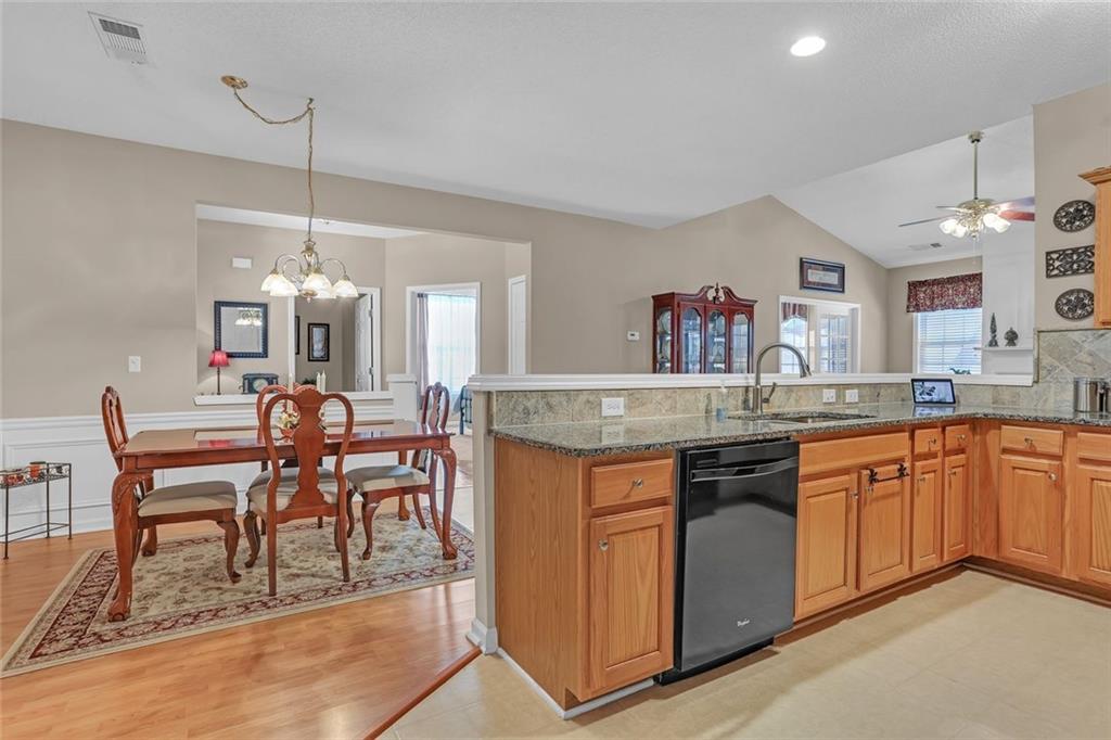 314 Gable Brook Drive Southwest Grayson, GA 30017 - Photo 20 of 26 a kitchen with granite countertop dining table chairs sink and granite counter tops