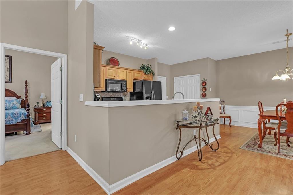 314 Gable Brook Drive Southwest Grayson, GA 30017 - Photo 23 of 26 a living room with stainless steel appliances kitchen island granite countertop furniture and a view of kitchen