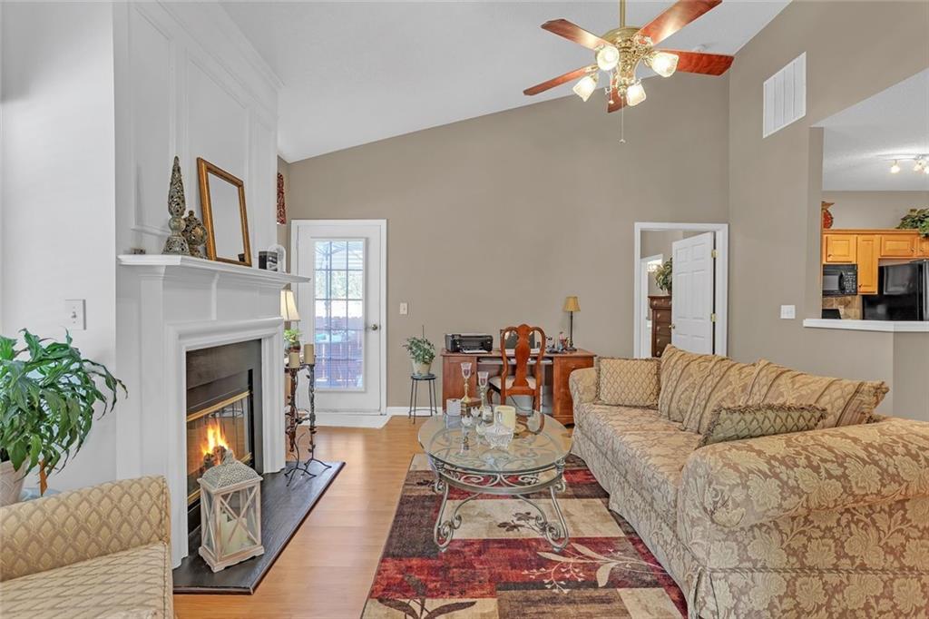 314 Gable Brook Drive Southwest Grayson, GA 30017 - Photo 6 of 26 a living room with furniture a fireplace and a chandelier