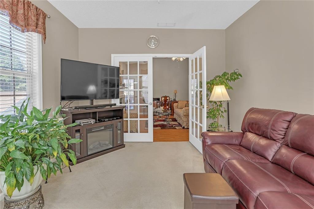 314 Gable Brook Drive Southwest Grayson, GA 30017 - Photo 7 of 26 a living room with furniture and a flat screen tv