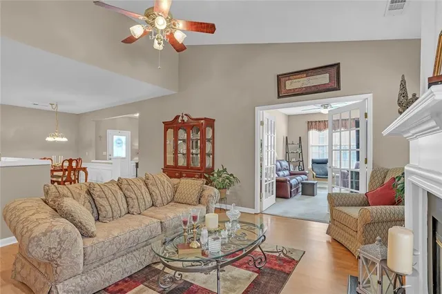 a living room with furniture a rug and a chandelier