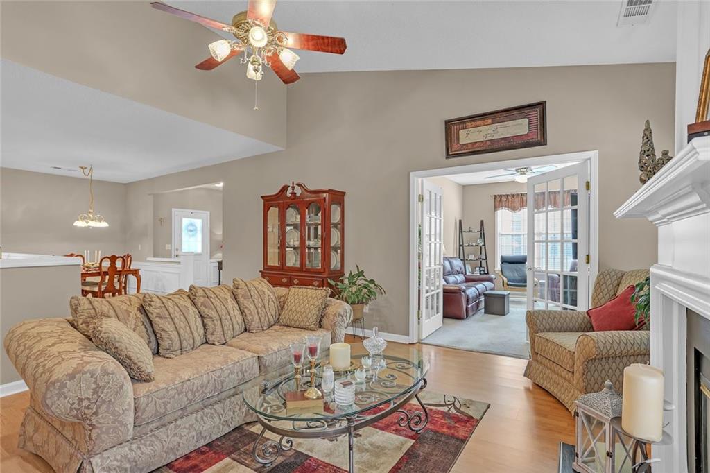 314 Gable Brook Drive Southwest Grayson, GA 30017 - Photo 9 of 26 a living room with furniture a rug and a chandelier