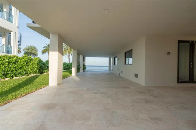 a large kitchen with stainless steel appliances a large counter top a large window and a kitchen view