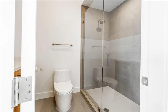 a bathroom with a glass shower door