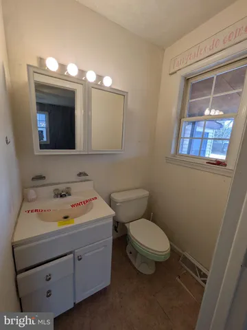 a bathroom with a sink toilet and mirror