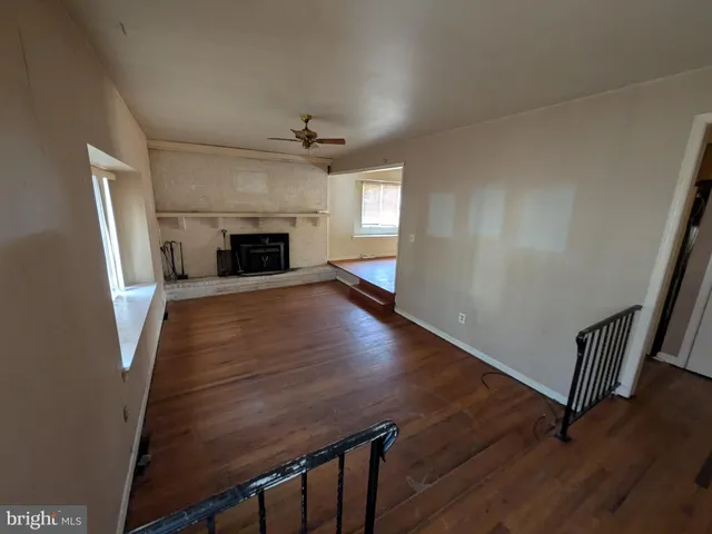 wooden floor in an empty room with a fireplace
