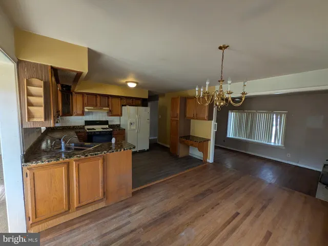 a kitchen that has a lot of cabinets and refrigerator
