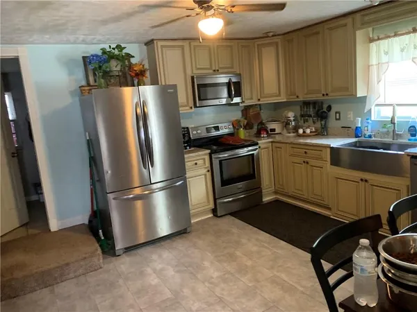 a kitchen with stainless steel appliances granite countertop a stove a refrigerator and a microwave