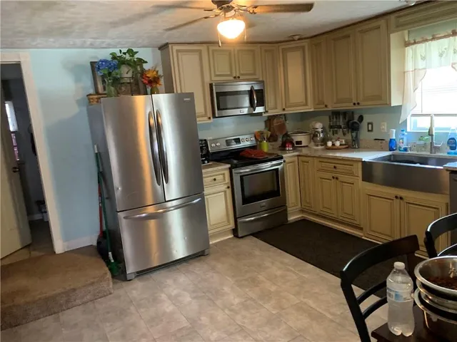 a kitchen with stainless steel appliances granite countertop a stove a refrigerator and a microwave