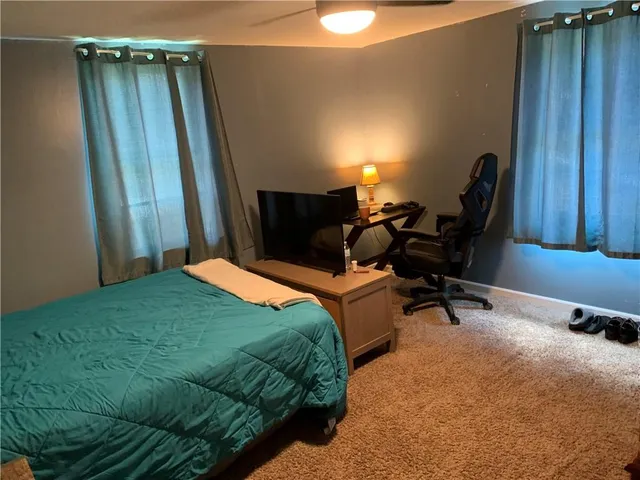 a bedroom with a bed and a mirror