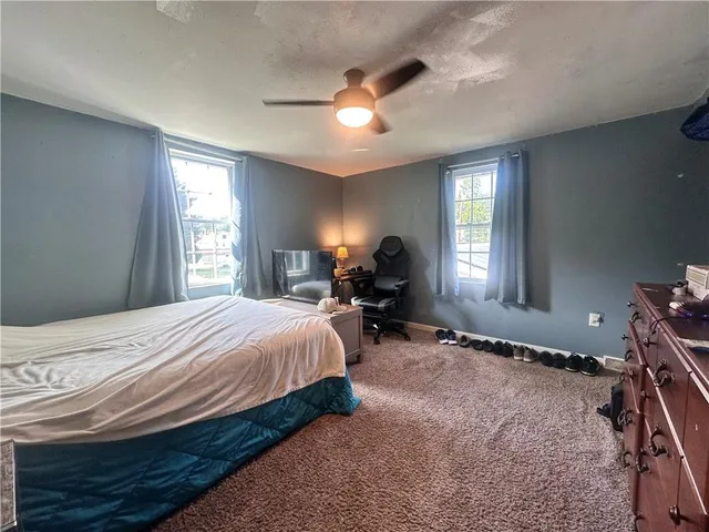 a bed room with a bed and a window